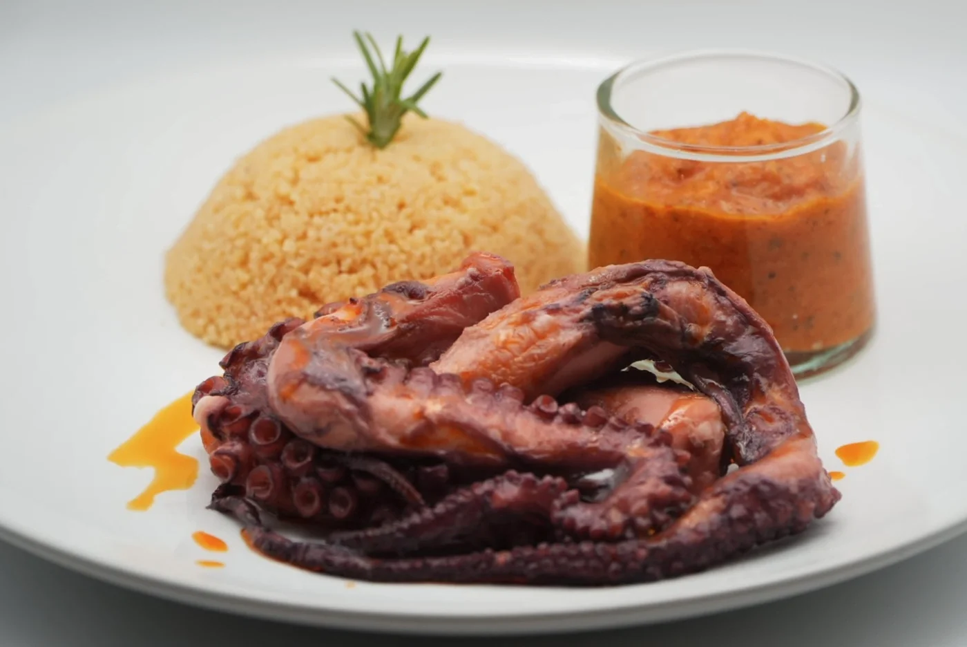 Octopus, romesco sauce, and flavored semolina