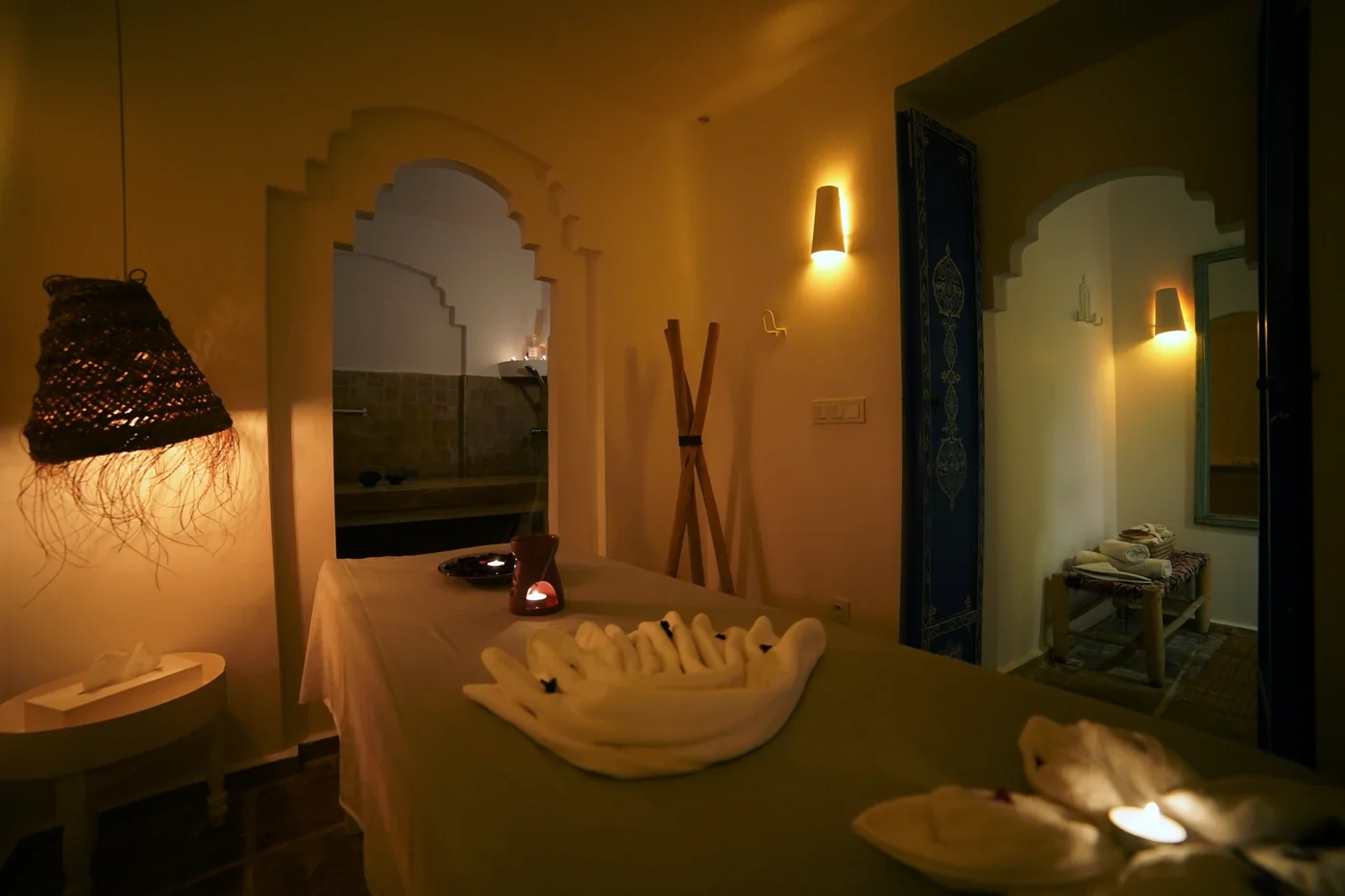 Hammam massage room with decorative folded towels and lit candles