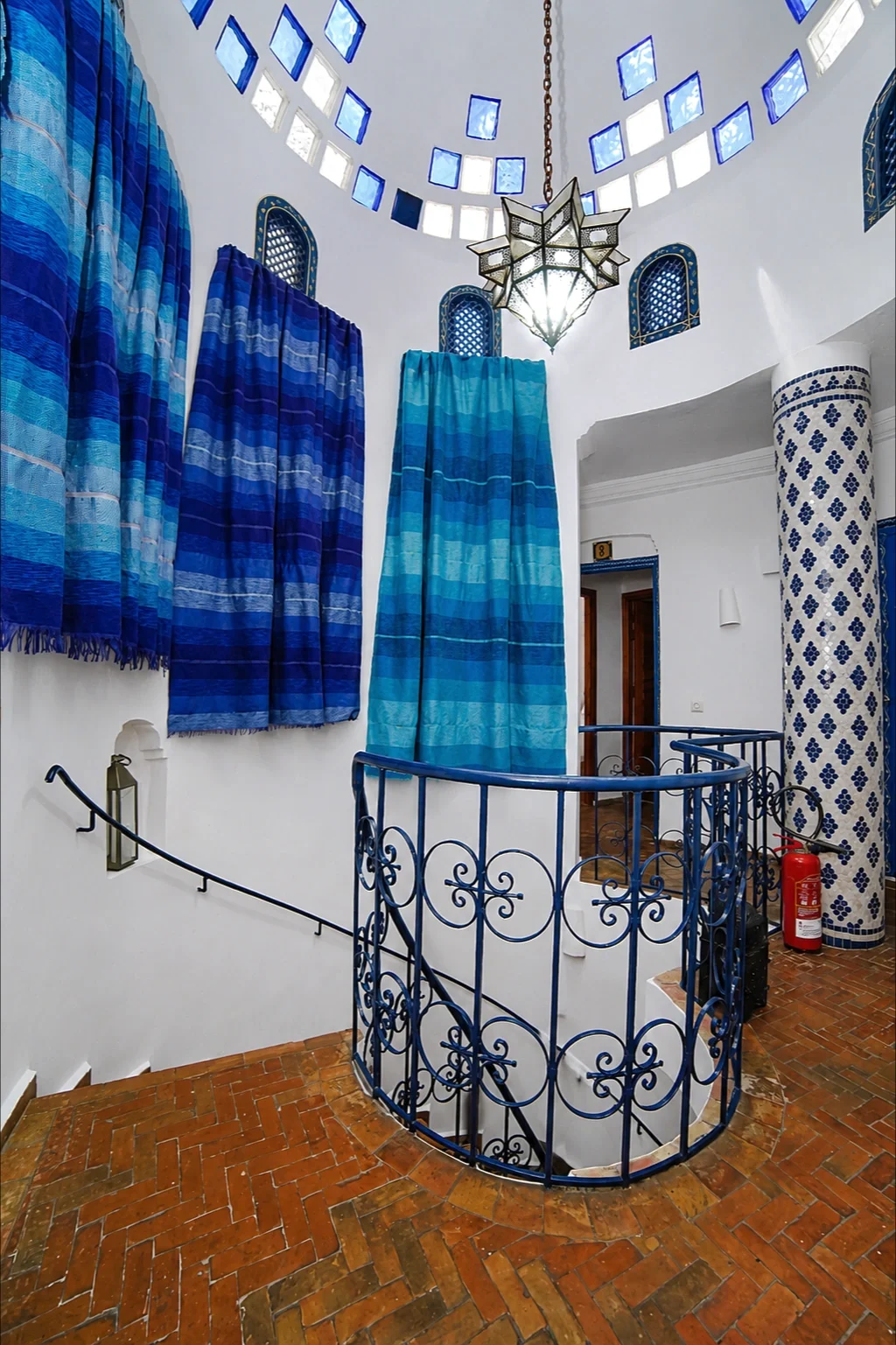 Spiral staircase next to a tiled column