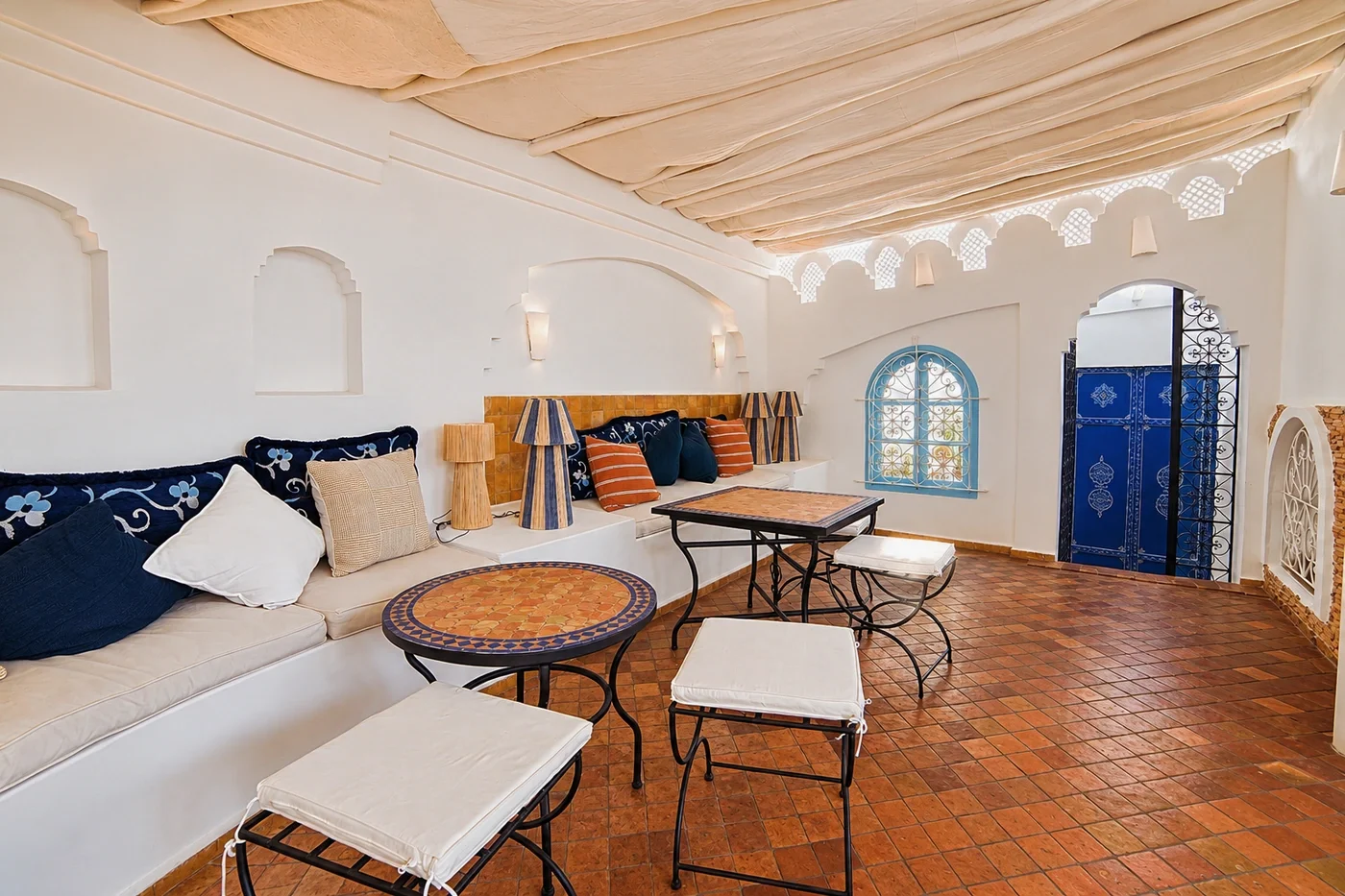 Corner with Moroccan cushions and tables on the hotel terrace